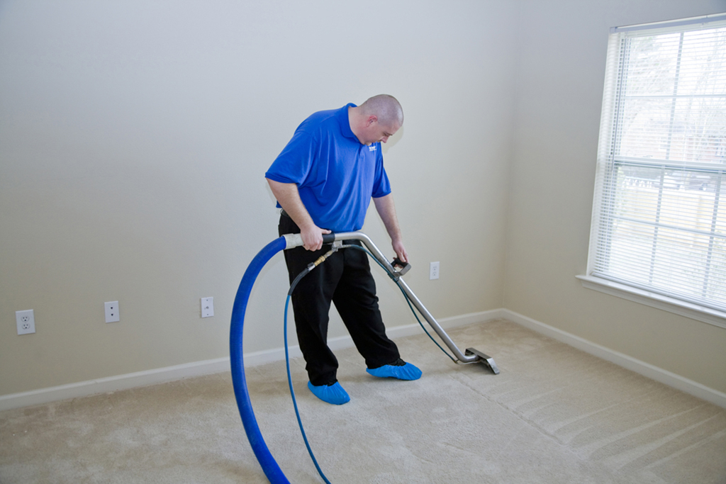 man steam cleaning carpets