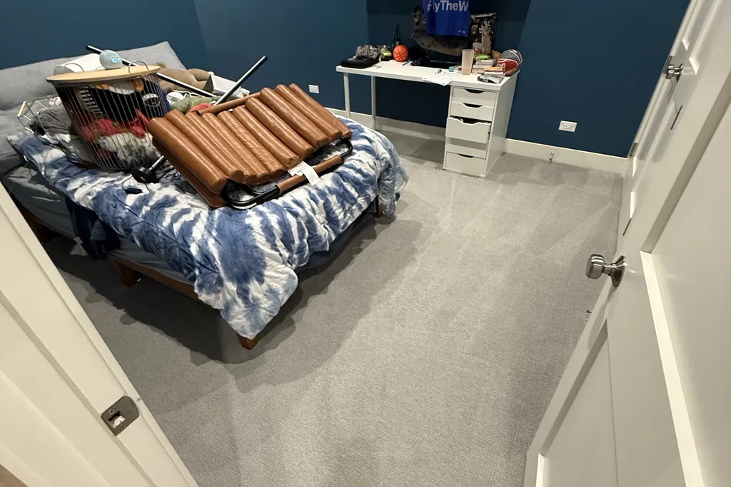 Bedroom in a North Center Chicago condo with small items lifted off the floor for wall-to-wall carpet cleaning