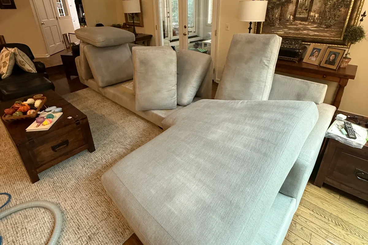 Seat cushion face on the sectional showing body-contact soiling before cleaning
