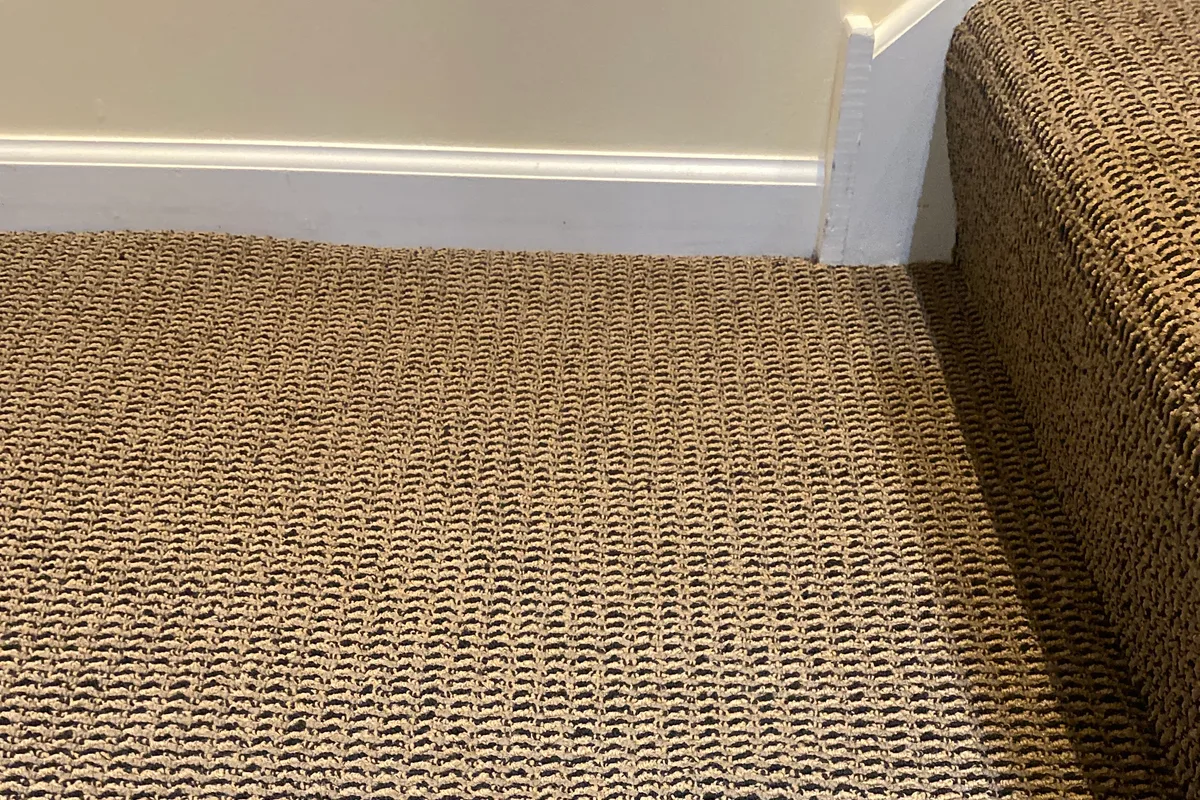 Wool carpet in the master bedroom before cleaning, cut and fitted to the room