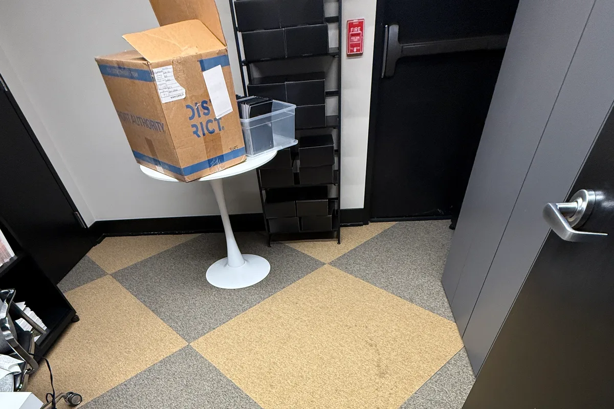 Wool area rug laid over office carpet before on-site cleaning in Chicago