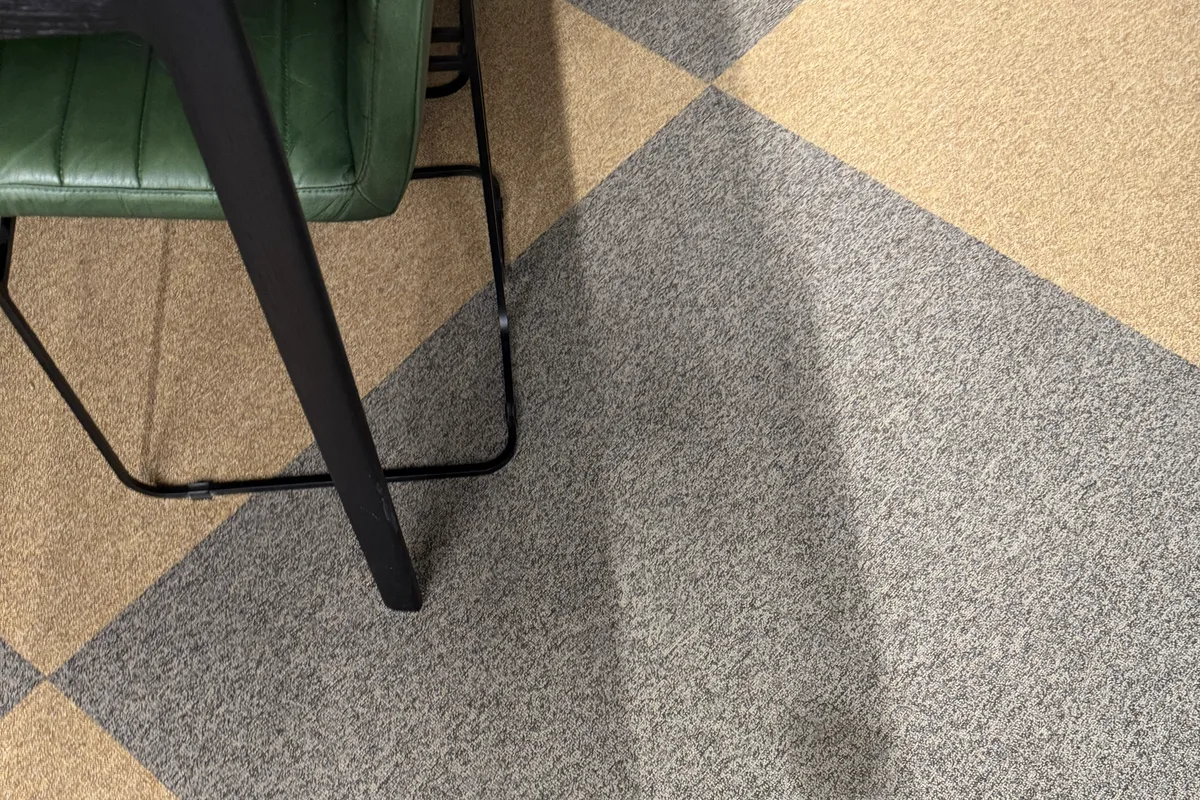 Hot water extraction wand pass across commercial carpet in an office space
